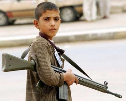 iraq boy totting a gun